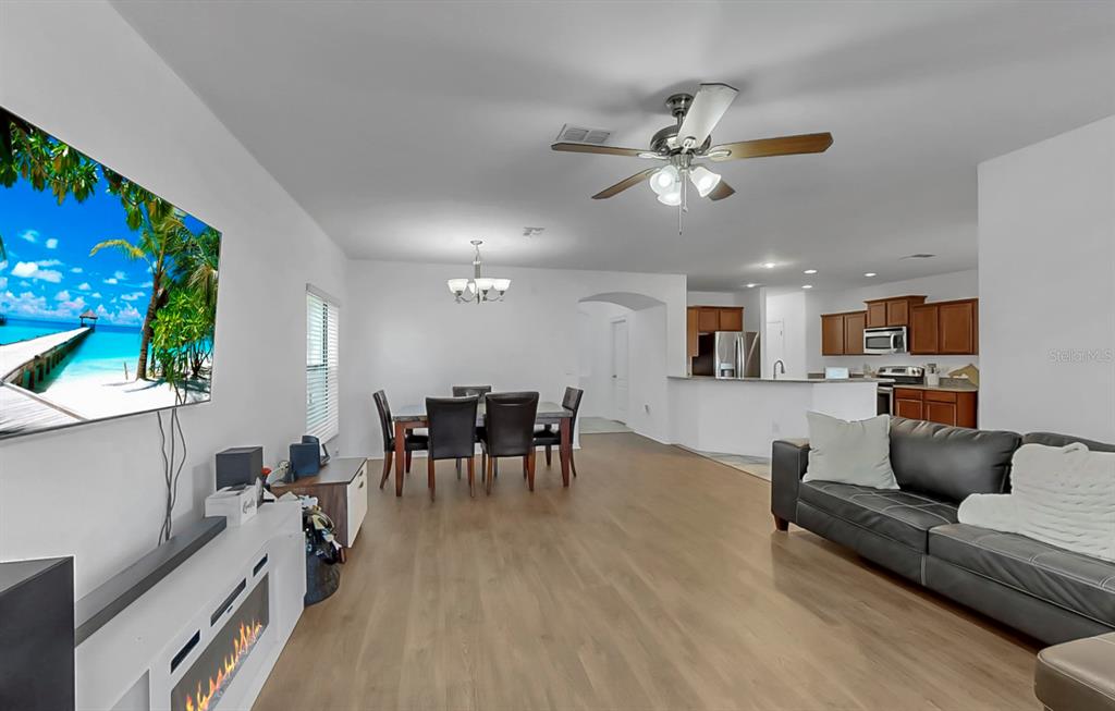 10012 Newminster Loop Ruskin, FL 33573 - Photo 22 of 59 a living room with furniture and a wooden floor