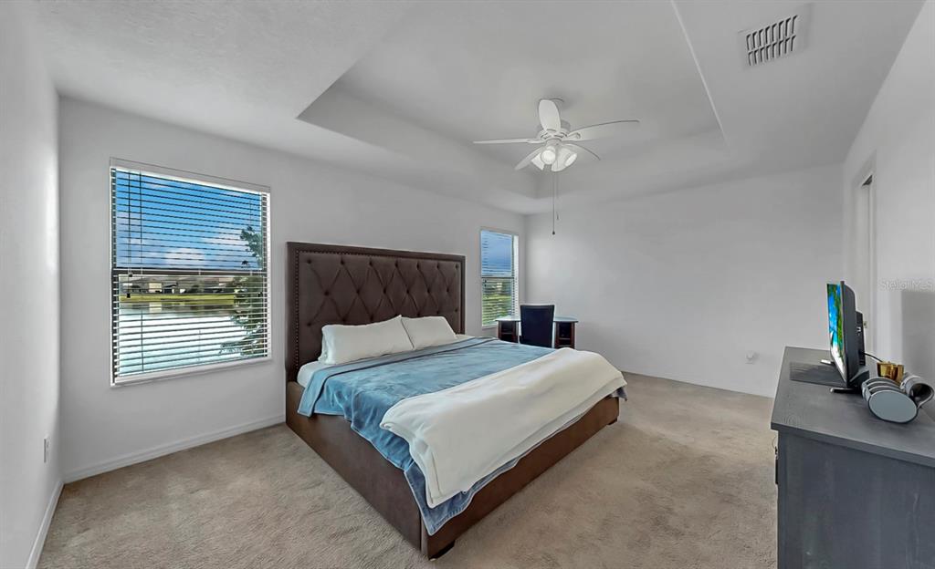 10012 Newminster Loop Ruskin, FL 33573 - Photo 26 of 59 a bedroom with a bed and a dresser next to a window
