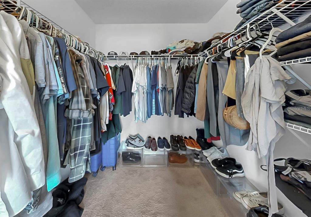 10012 Newminster Loop Ruskin, FL 33573 - Photo 29 of 59 a view of walk in closet with clothes and shoes