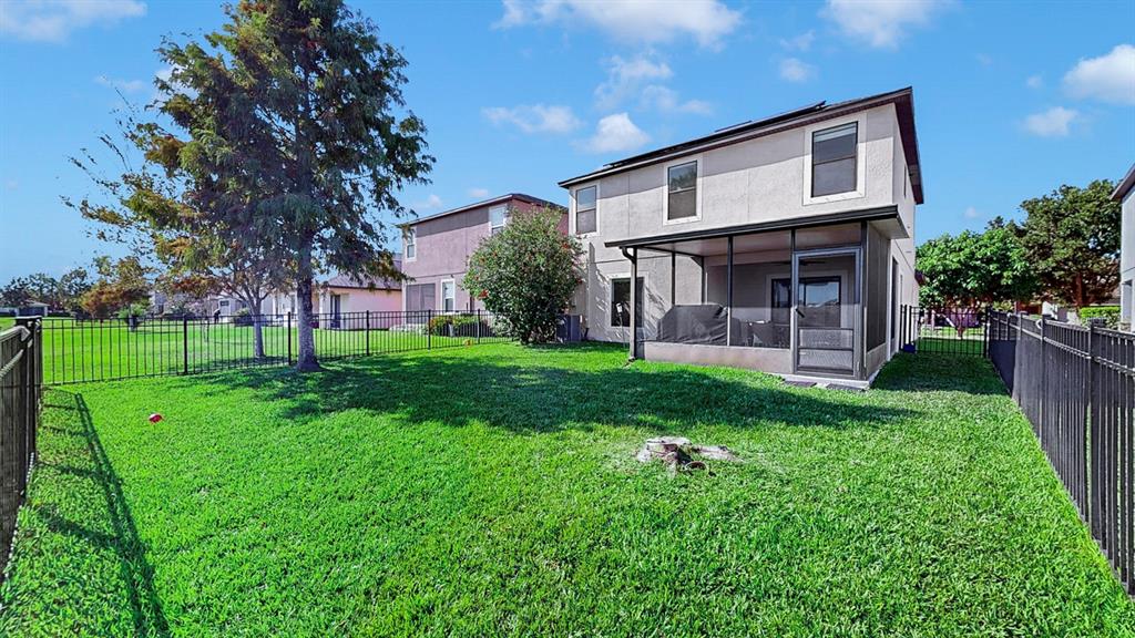 10012 Newminster Loop Ruskin, FL 33573 - Photo 44 of 59 a front view of a house with a yard