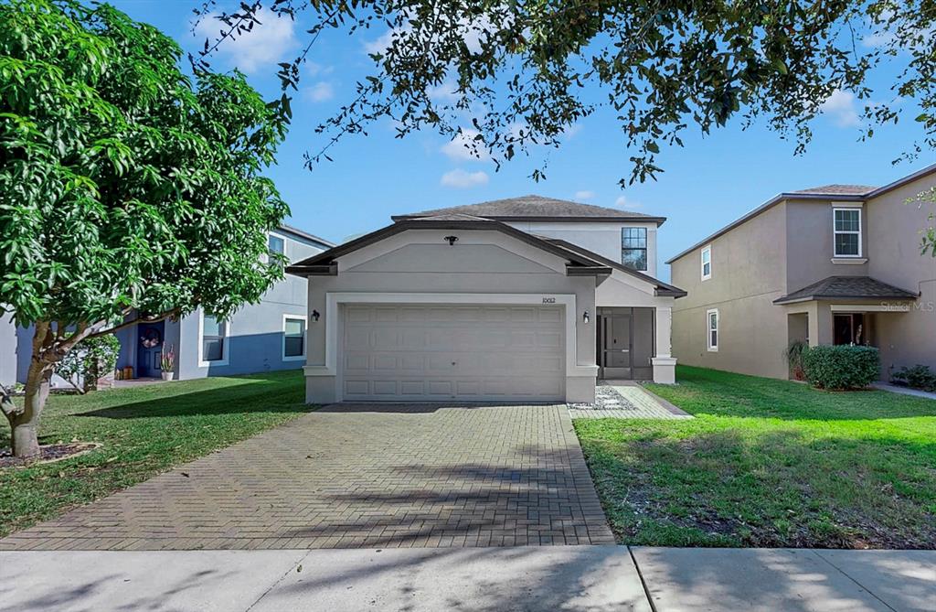 10012 Newminster Loop Ruskin, FL 33573 - Photo 45 of 59 a front view of a house with a yard and garage