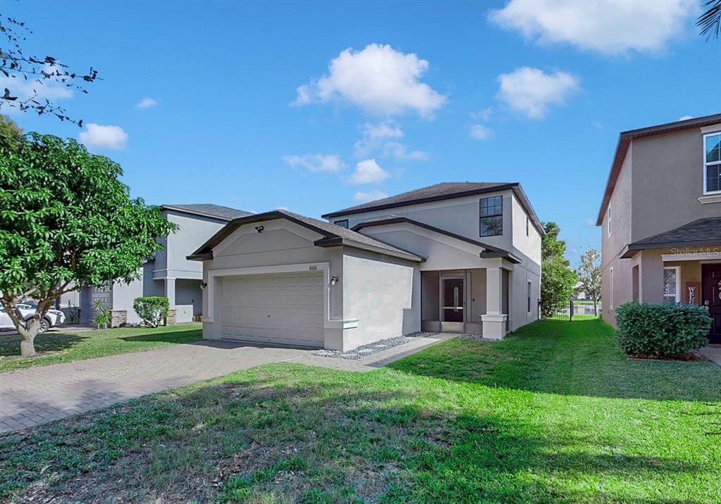 10012 Newminster Loop Ruskin, FL 33573 - Photo 46 of 59 a front view of house with yard and green space