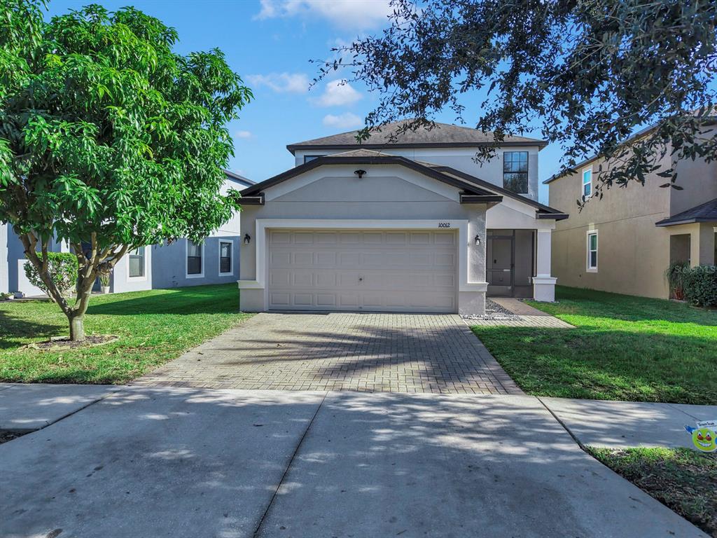 10012 Newminster Loop Ruskin, FL 33573 - Photo 54 of 59 a front view of house with yard and green space