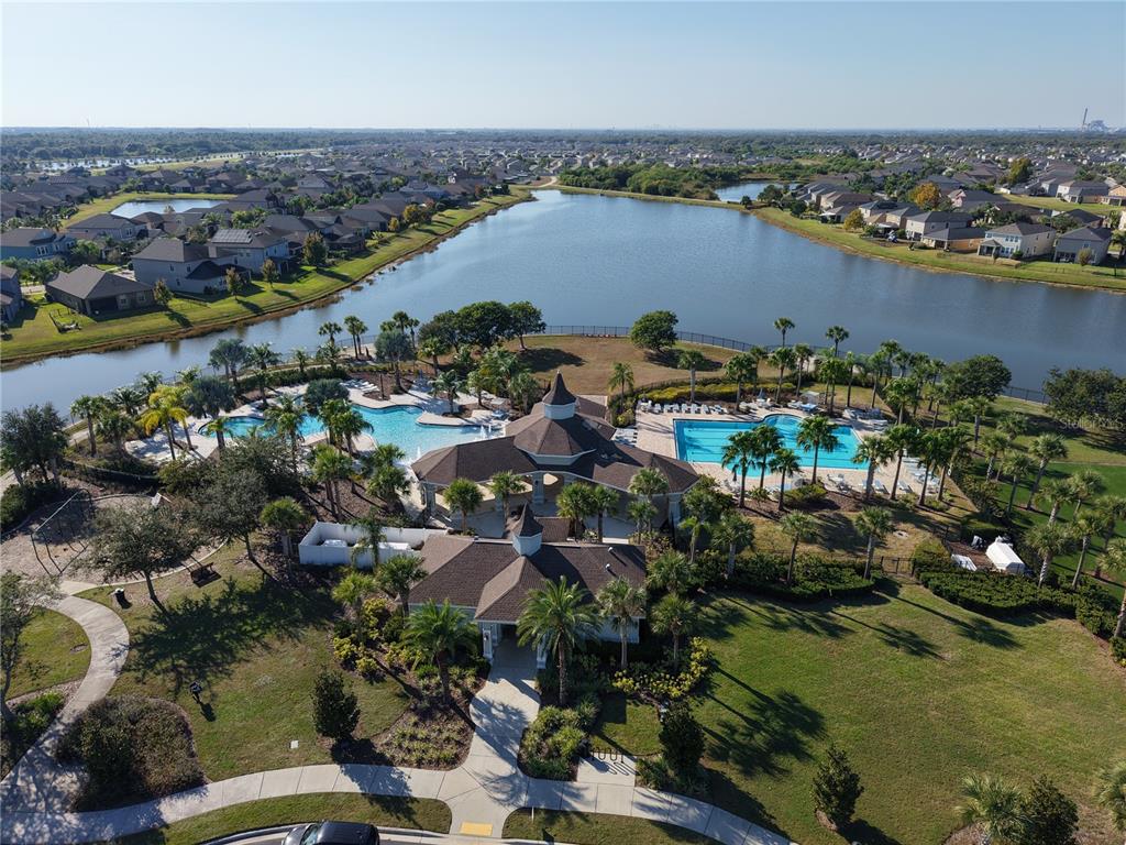 10012 Newminster Loop Ruskin, FL 33573 - Photo 57 of 59 an aerial view of a city with lots of residential buildings ocean and mountain view in back