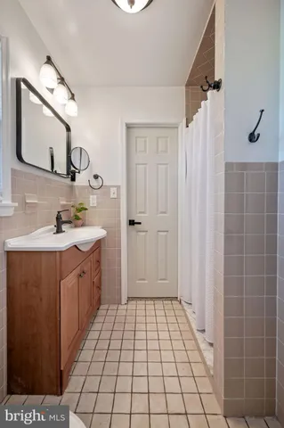a bathroom with a sink a mirror and a shower