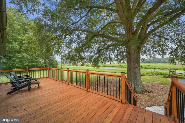 a balcony with wooden floor table and chairs