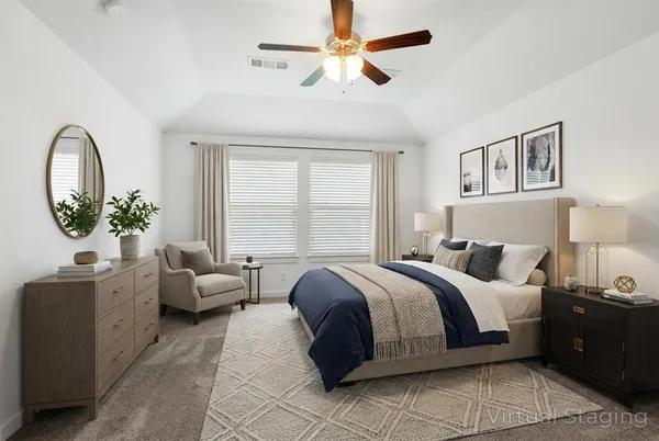a spacious bedroom with a bed and a chandelier