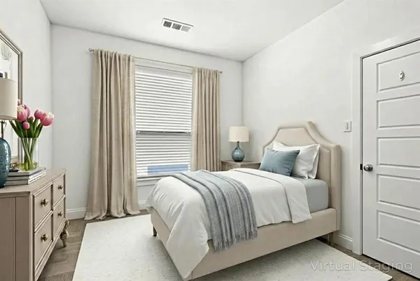 a bedroom with a bed and a window