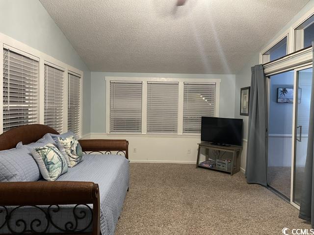 469 Sandpebble Surfside Beach, SC 29575 - Photo 14 of 39 Bedroom with vaulted ceiling, a textured ceiling, and carpet floors