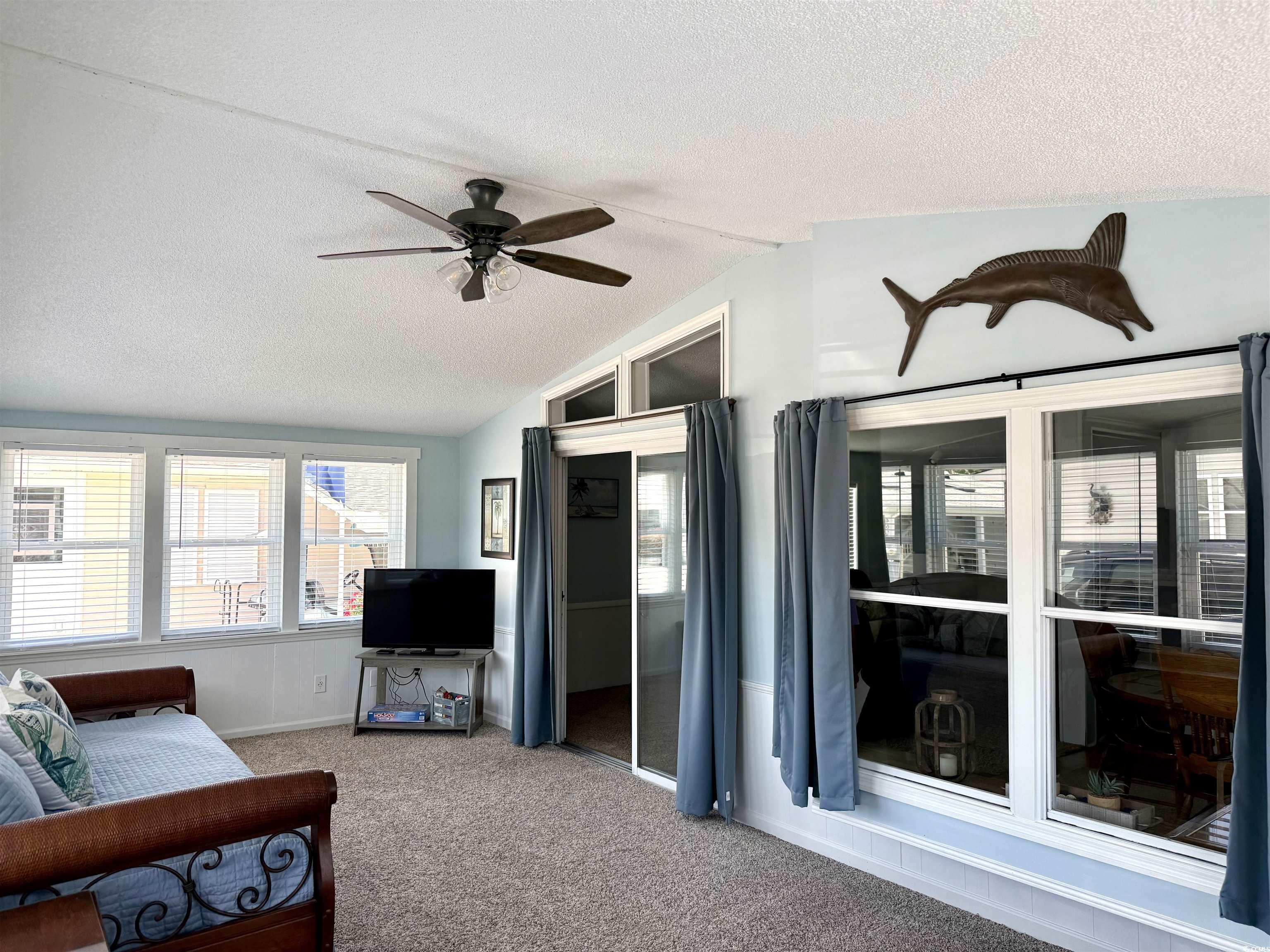 469 Sandpebble Surfside Beach, SC 29575 - Photo 15 of 39 Living room with a ceiling fan, vaulted ceiling, a textured ceiling, and carpet