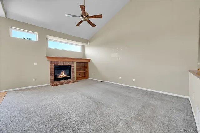 a view of an empty room with fire place