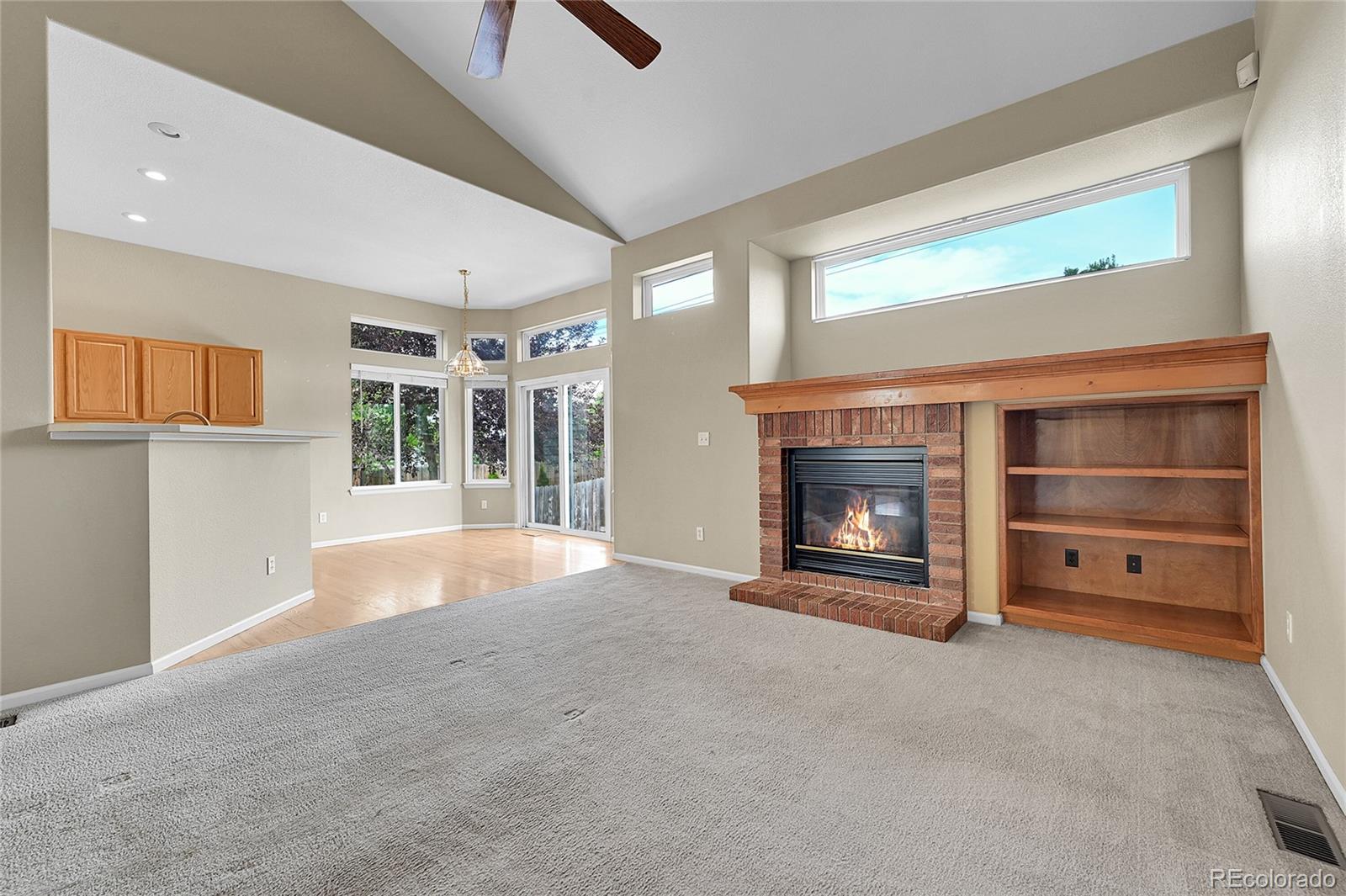 19115 East Belleview Place Centennial, CO 80015 - Photo 13 of 47 a view of an empty room with a fireplace and a window