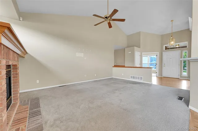 a view of a kitchen with a sink and a refrigerator