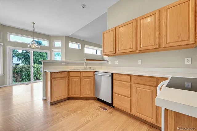 a kitchen with granite countertop white cabinets and a sink