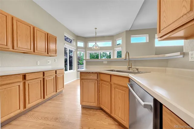 a kitchen with stainless steel appliances granite countertop a sink and a stove