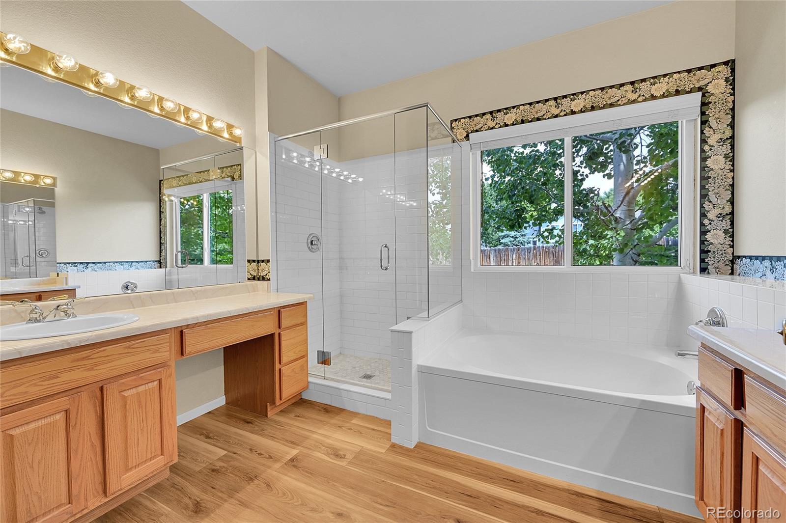 19115 East Belleview Place Centennial, CO 80015 - Photo 23 of 47 a spacious bathroom with a tub sink shower and mirror