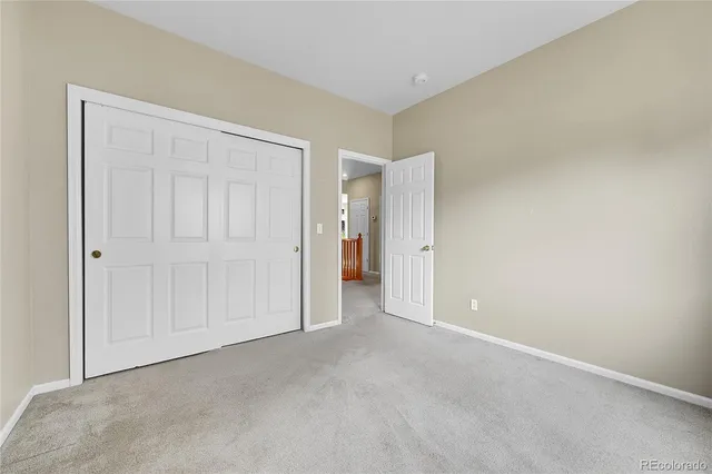 a view of an empty room and closet area