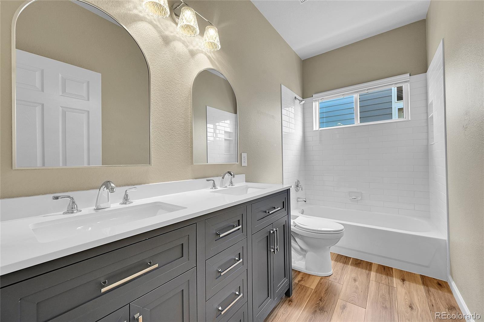 19115 East Belleview Place Centennial, CO 80015 - Photo 26 of 47 a bathroom with a double vanity sink toilet and a mirror