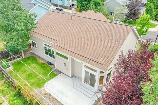 a white building with a large window and yard