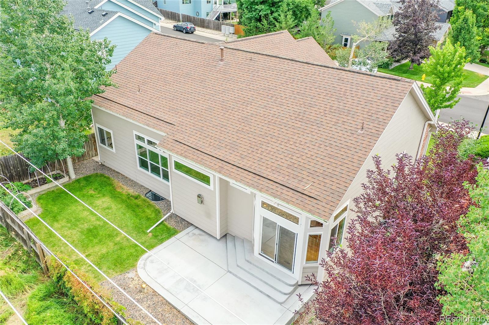 19115 East Belleview Place Centennial, CO 80015 - Photo 33 of 47 a white building with a large window and yard