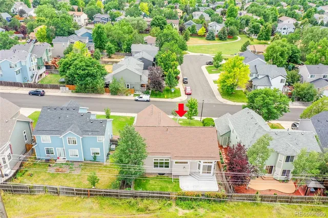 an aerial view of house with yard swimming pool and outdoor seating