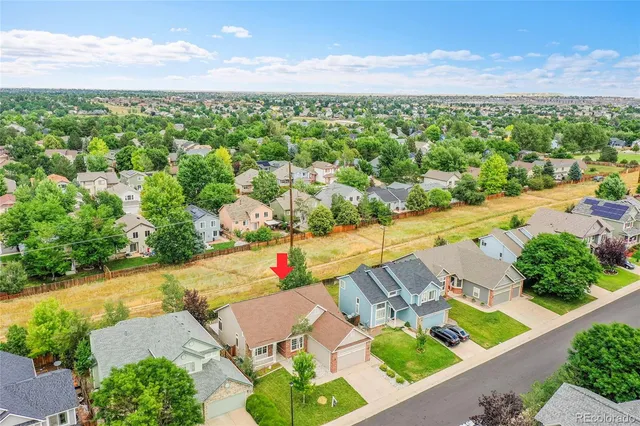 an aerial view of residential houses with outdoor space and street view