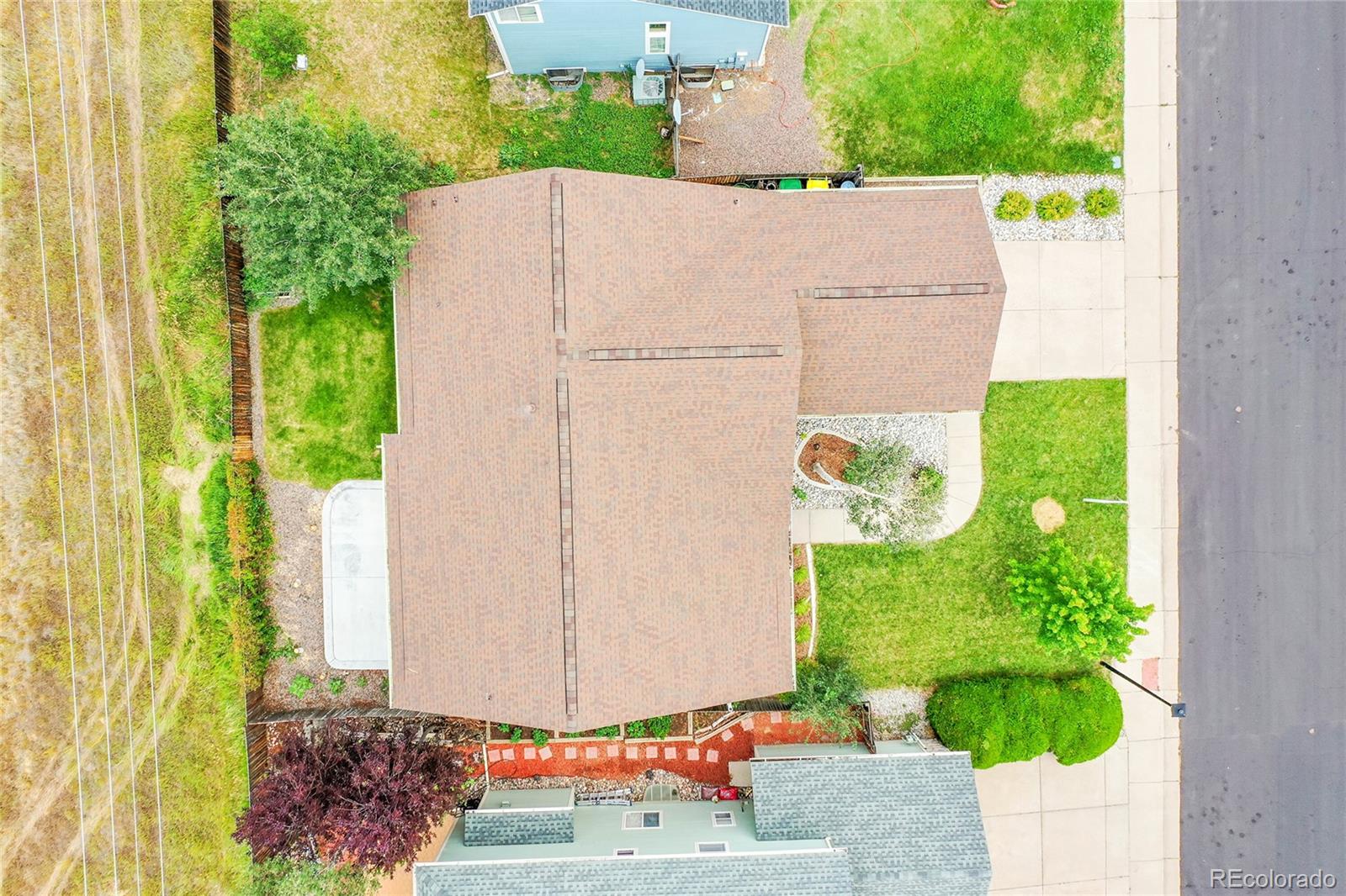 19115 East Belleview Place Centennial, CO 80015 - Photo 39 of 47 a white house with a yard and plants