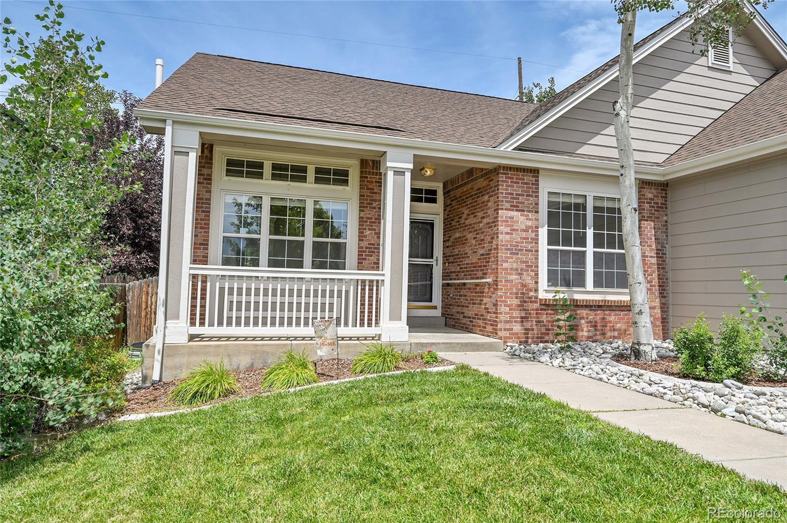 19115 East Belleview Place Centennial, CO 80015 - Photo 44 of 47 a front view of a house with a garden