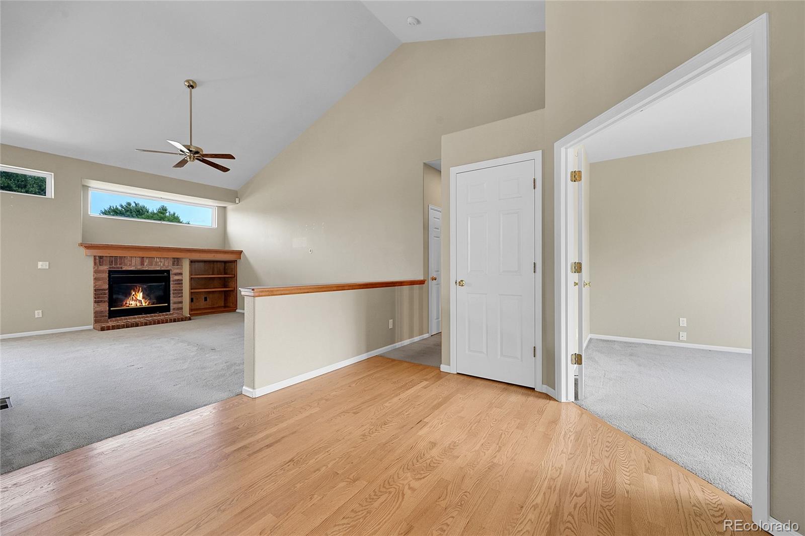 19115 East Belleview Place Centennial, CO 80015 - Photo 6 of 47 an empty room with windows and a fireplace
