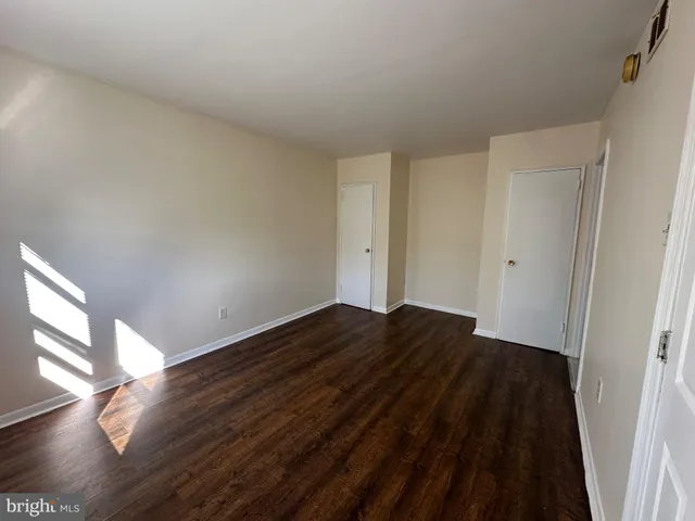 a view of bedroom with wooden floor