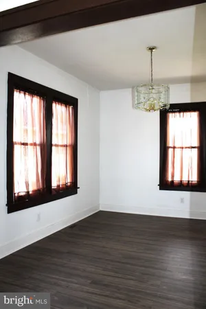 a front door view with a window and wooden floor