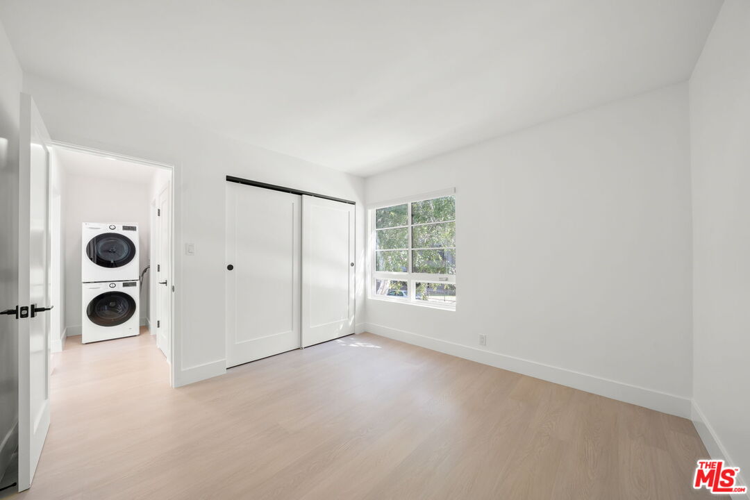1201 Ohio Avenue, Unit 4 Long Beach, CA 90804 - Photo 16 of 18 a view of an empty room with window and chandelier fan