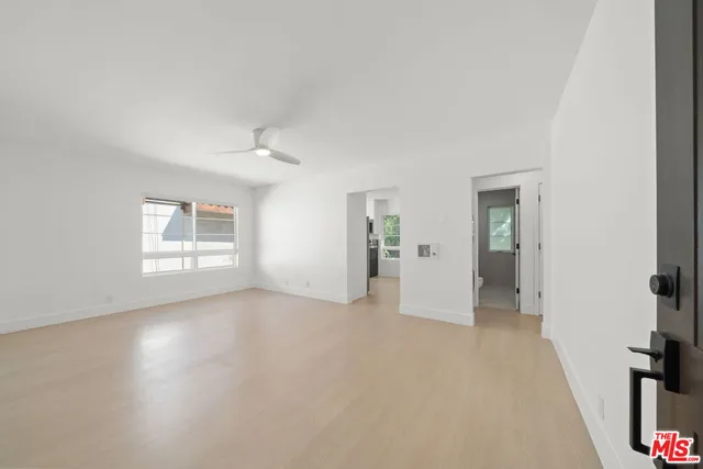 an empty room with windows and closet