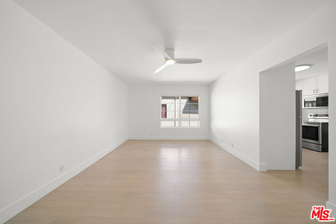 1201 Ohio Avenue, Unit 4 Long Beach, CA 90804 - Photo 4 of 18 wooden floor in an empty room with a kitchen