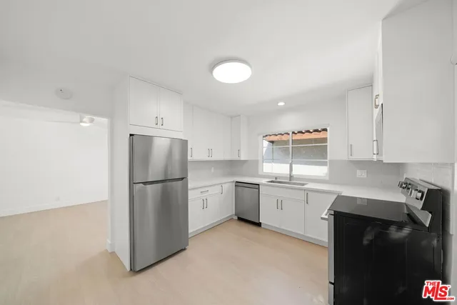 a kitchen with a refrigerator sink and stove