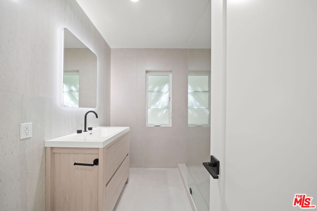 1201 Ohio Avenue, Unit 4 Long Beach, CA 90804 - Photo 8 of 18 a bathroom with a sink a mirror and shower