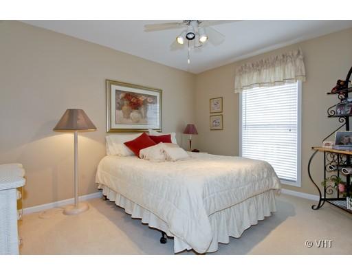2035 Forest Ridge Road St. Charles, IL 60174 - Photo 12 of 16 a bedroom with a bed a painting on the wall and a window