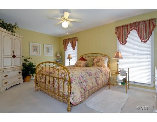 2035 Forest Ridge Road St. Charles, IL 60174 - Photo 10 of 16 a bedroom with a bed and a chandelier
