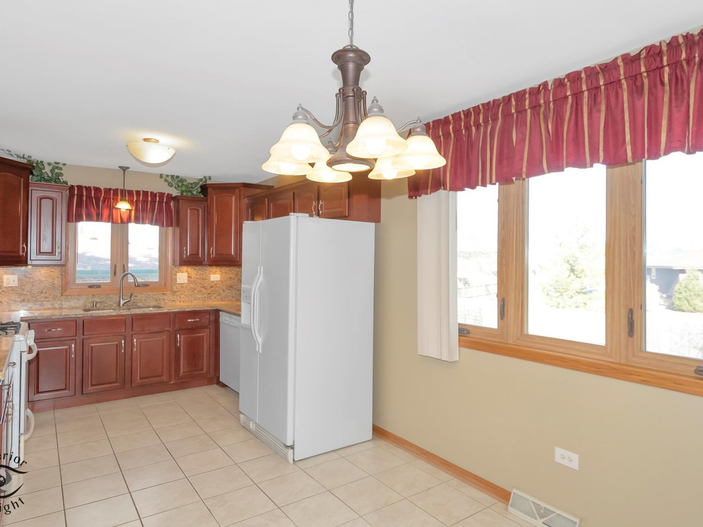 14501 South Abbott Road East Homer Glen, IL 60491 - Photo 10 of 31 a kitchen with stainless steel appliances granite countertop a refrigerator a sink dishwasher and wooden cabinets with large window