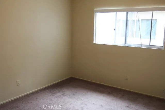 a room with a sink cabinets and a window