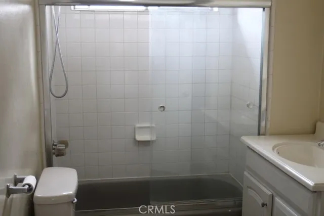 a bathroom with a shower a toilet and sink