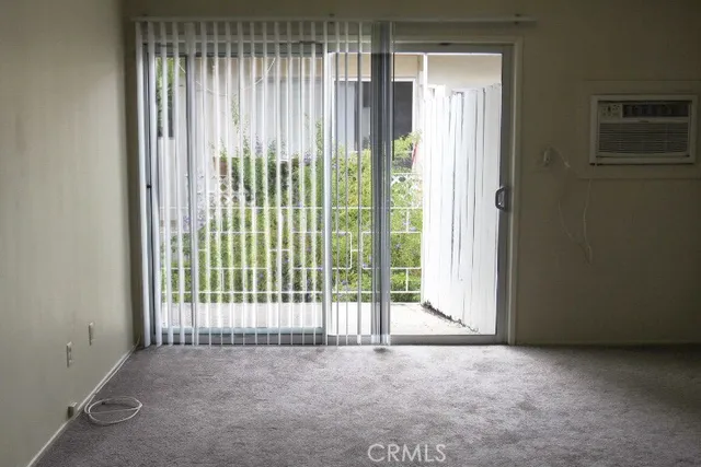 a view of an empty room with floor to ceiling window