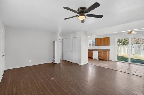 an empty room with wooden floor and fireplace