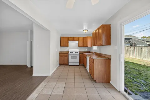 a kitchen with a cabinets a sink and a stove top oven