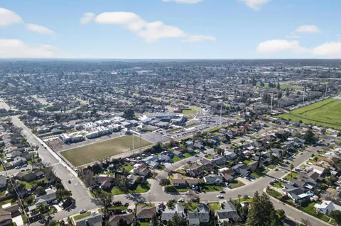 an aerial view of residential houses with city view