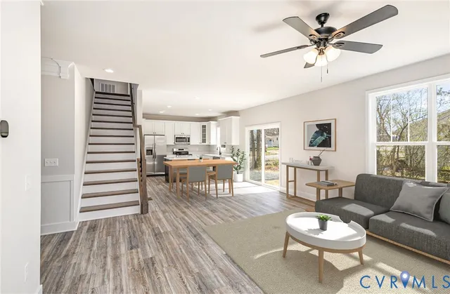 a living room with furniture and a wooden floor