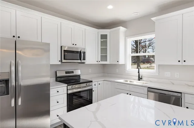 a kitchen with a sink stove and cabinets