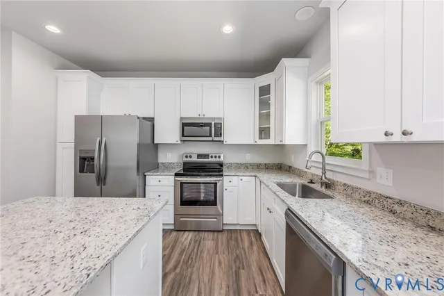 a kitchen with a sink stove and refrigerator