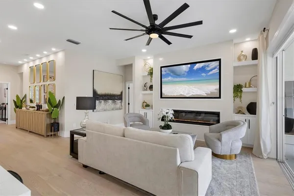 a living room with stainless steel appliances kitchen island furniture and a view of kitchen