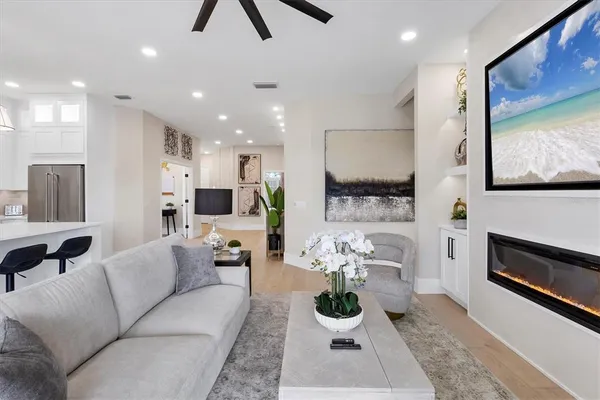 a kitchen with a dining table chairs stainless steel appliances and cabinets